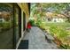 Paver patio offers a tranquil outdoor seating area surrounded by lush landscaping at 7340 Villa D Este Drive, Sarasota, FL 34238