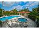 Inviting community pool and spa with lounge chairs and tables, providing a perfect setting for outdoor enjoyment at 7340 Villa D Este Drive, Sarasota, FL 34238