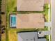 Aerial view of a home showcasing the roof, a screened-in pool, and a well-maintained lawn at 8163 Redonda Loop, Lakewood Ranch, FL 34202