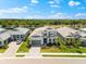 Beautiful home with manicured lawn, professional landscaping, and a paved driveway leading to the attached garage at 8163 Redonda Loop, Lakewood Ranch, FL 34202