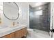 Modern bathroom featuring a sleek vanity, stylish mirror, and a glass-enclosed shower with gray tiling at 8163 Redonda Loop, Lakewood Ranch, FL 34202
