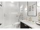 Charming bathroom featuring an enclosed shower with white tiling and a vanity with gold fixtures at 8163 Redonda Loop, Lakewood Ranch, FL 34202