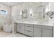 An elegant bathroom with marble walls, a soaking tub, walk-in shower, and a spacious vanity with dual sinks at 8163 Redonda Loop, Lakewood Ranch, FL 34202