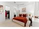 Cozy bedroom featuring a large bed, with attached bathroom and walk in closet at 8163 Redonda Loop, Lakewood Ranch, FL 34202