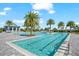 Large community pool with plenty of seating available amidst lush tropical landscaping, perfect for relaxation at 8163 Redonda Loop, Lakewood Ranch, FL 34202