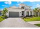 Beautiful two-story home boasts manicured landscaping, paver driveway, and attached garage at 8163 Redonda Loop, Lakewood Ranch, FL 34202