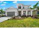 Beautiful two-story home featuring lush landscaping, a well-maintained lawn, and a spacious driveway at 8163 Redonda Loop, Lakewood Ranch, FL 34202