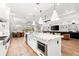 Bright, open kitchen and dining area with a large island, stainless appliances, and seating at 8163 Redonda Loop, Lakewood Ranch, FL 34202
