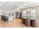 Modern kitchen and dining area with stainless steel appliances, ample cabinet space, and stylish lighting at 8163 Redonda Loop, Lakewood Ranch, FL 34202