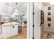 Open kitchen with stone countertops, black accents, and stainless appliances overlook the cozy living area at 8163 Redonda Loop, Lakewood Ranch, FL 34202