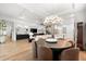 Open-concept living space with a large dining table and modern kitchen at 8163 Redonda Loop, Lakewood Ranch, FL 34202