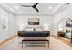 Tranquil bedroom with wood floors, a tray ceiling with ceiling fan and a serene painting at 8163 Redonda Loop, Lakewood Ranch, FL 34202