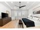 Spacious main bedroom has natural light, modern ceiling fan, and dark wood dresser at 8163 Redonda Loop, Lakewood Ranch, FL 34202