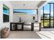 Outdoor kitchen with stainless steel appliances and stylish tile backsplash at 8163 Redonda Loop, Lakewood Ranch, FL 34202