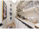 Well-organized pantry with shelving, storage containers, and a decorative curtain detail at 8163 Redonda Loop, Lakewood Ranch, FL 34202