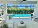 An inviting covered patio featuring stylish furniture, a ceiling fan, and a view of the pool at 8163 Redonda Loop, Lakewood Ranch, FL 34202
