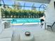 This screened in patio with ample seating overlooks a luxurious pool, creating a peaceful and private outdoor retreat at 8163 Redonda Loop, Lakewood Ranch, FL 34202