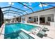 A stunning screened pool and patio area offers a luxurious outdoor living space for relaxation and entertaining at 8163 Redonda Loop, Lakewood Ranch, FL 34202