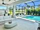 Relaxing screened pool area with comfortable seating and outdoor kitchen perfect for enjoying the outdoors at 8163 Redonda Loop, Lakewood Ranch, FL 34202
