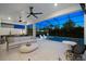 This luxurious screened outdoor living area features a pool, an outdoor kitchen and comfortable seating at 8163 Redonda Loop, Lakewood Ranch, FL 34202