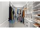 Spacious walk-in closet with custom shelving and storage for clothing, shoes, and accessories at 8163 Redonda Loop, Lakewood Ranch, FL 34202