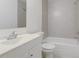 Bathroom featuring a gray vanity with a white sink and a shower-tub combination with gray tile surround at 842 31St E Ave, Bradenton, FL 34208
