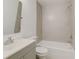 Bathroom featuring a gray vanity with a white sink and a shower-tub combination with gray tile surround at 842 31St E Ave, Bradenton, FL 34208