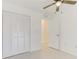 Bright bedroom featuring neutral walls, tiled floors, a ceiling fan, and a closet for ample storage at 842 31St E Ave, Bradenton, FL 34208