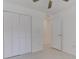 Bright bedroom featuring neutral walls, tiled floors, a ceiling fan, and a closet for ample storage at 842 31St E Ave, Bradenton, FL 34208
