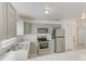 Well-lit kitchen featuring stainless appliances, marbled countertops, and classic cabinets at 842 31St E Ave, Bradenton, FL 34208