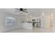 Open-concept kitchen and living room featuring stainless appliances, sleek counters, and tile flooring at 842 31St E Ave, Bradenton, FL 34208