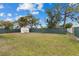 Large, green backyard with privacy fence and storage shed at 8718 Gaillard Ave, North Port, FL 34287