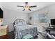 Comfortable bedroom with a queen-sized bed, ceiling fan, and a view of the backyard at 8718 Gaillard Ave, North Port, FL 34287