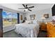 Cozy bedroom with a comfortable queen-sized bed, a large window view, and stylish ceiling fan at 8718 Gaillard Ave, North Port, FL 34287