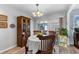 Cozy dining room featuring a table set for four and sliding glass doors to the patio at 8718 Gaillard Ave, North Port, FL 34287
