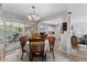 Bright dining room with a table for four and sliding glass doors to the patio at 8718 Gaillard Ave, North Port, FL 34287