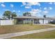 Charming single-story home with a well-maintained lawn and cozy front porch seating area at 8718 Gaillard Ave, North Port, FL 34287
