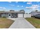 Home exterior with a long driveway and a seating area on the porch at 8718 Gaillard Ave, North Port, FL 34287