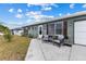 Charming home exterior with seating area, walkway and flower bed at 8718 Gaillard Ave, North Port, FL 34287