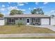 Charming single-story home featuring a well-maintained lawn, inviting front door, and attached garage at 8718 Gaillard Ave, North Port, FL 34287