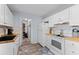 Bright kitchen with white cabinets, butcher block countertops, white appliances, and lots of storage at 8718 Gaillard Ave, North Port, FL 34287