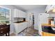 Well-equipped kitchen with white cabinets, butcher block countertops, and a view into the utility area at 8718 Gaillard Ave, North Port, FL 34287