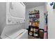 Practical laundry room featuring a stacked washer and dryer, and ample storage shelves at 8718 Gaillard Ave, North Port, FL 34287