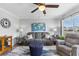 Cozy living room with gray sofa, blue ottoman, ceiling fan and decor at 8718 Gaillard Ave, North Port, FL 34287