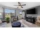 Bright living room with a comfortable recliner, TV, and a view of the front yard at 8718 Gaillard Ave, North Port, FL 34287