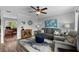 Comfortable living room with gray sofa, blue ottoman, ceiling fan, and stylish decor at 8718 Gaillard Ave, North Port, FL 34287