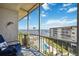 Relaxing screened balcony featuring a serene view of the pool and the scenic water view at 1650 1St W Ave # 503B, Bradenton, FL 34205