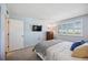 Comfortable bedroom with a full bed, tv and bright, shuttered window providing natural light at 1650 1St W Ave # 503B, Bradenton, FL 34205