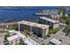 Aerial of a condominium with parking and landscaping near a river and marina at 1650 1St W Ave # 503B, Bradenton, FL 34205