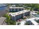Aerial view of a multi-story condominium featuring balconies, parking, and manicured landscaping at 1650 1St W Ave # 503B, Bradenton, FL 34205